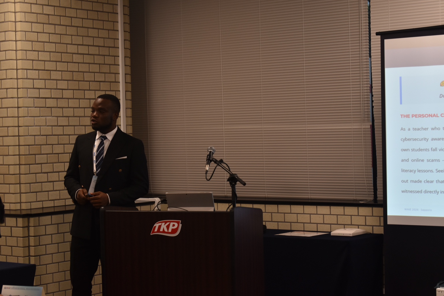Paul Teye speaking at a conference podium